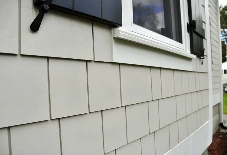 White house siding with black shutters and window, overlapping rectangular panels